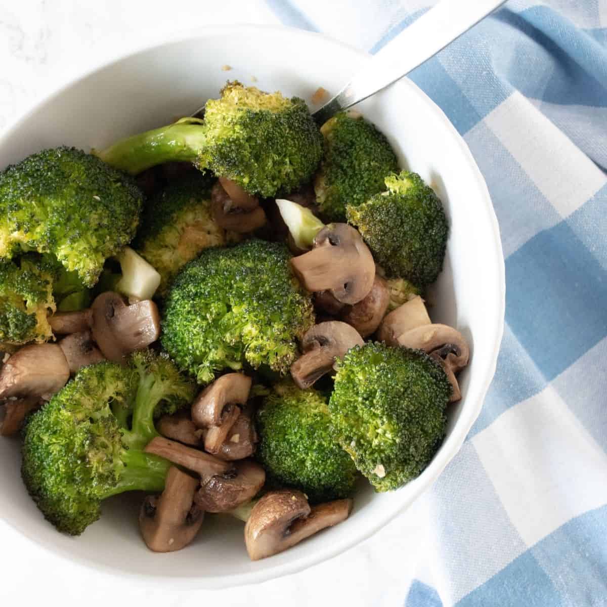Roasted broccoli and mushrooms in a bowl.