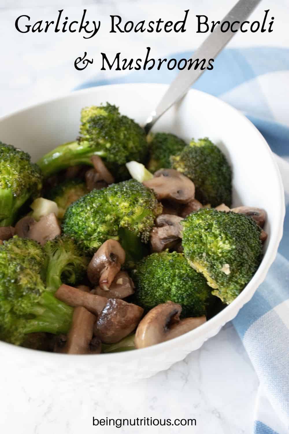 Roasted broccoli and mushrooms in a bowl. Text overlay: Garlicky Roasted Broccoli and Mushrooms.