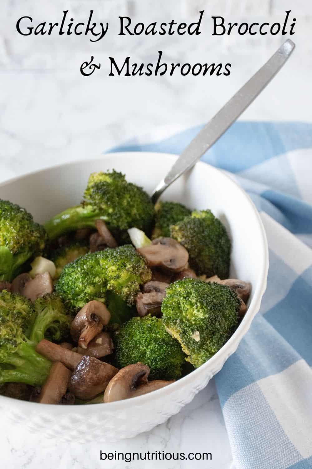 Roasted broccoli and mushrooms in a bowl. Text overlay: Garlicky Roasted Broccoli and Mushrooms.