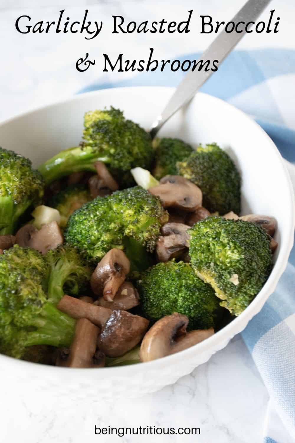 Roasted broccoli and mushrooms in a bowl. Text overlay: Garlicky Roasted Broccoli and Mushrooms.