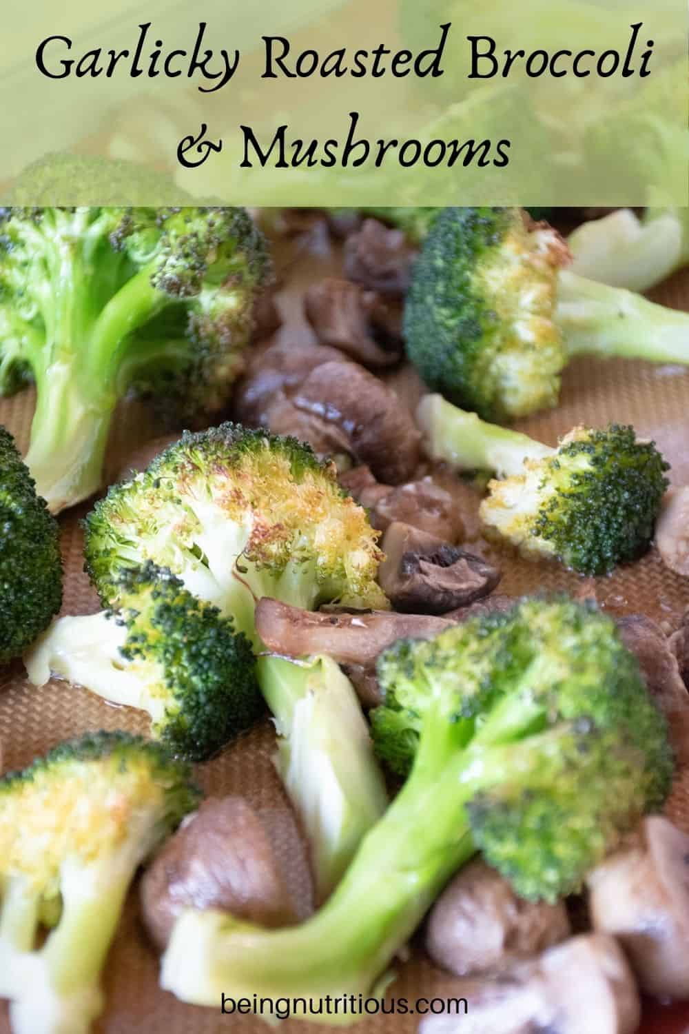 Close up of roasted broccoli and mushrooms on a baking sheet. Text overlay: Garlicky Roasted Broccoli and Mushrooms.