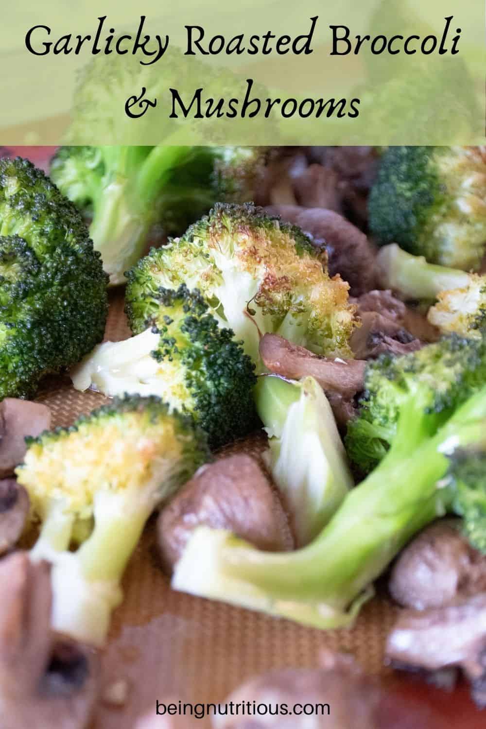 Close up of roasted broccoli and mushrooms on a baking sheet. Text overlay: Garlicky Roasted Broccoli and Mushrooms.