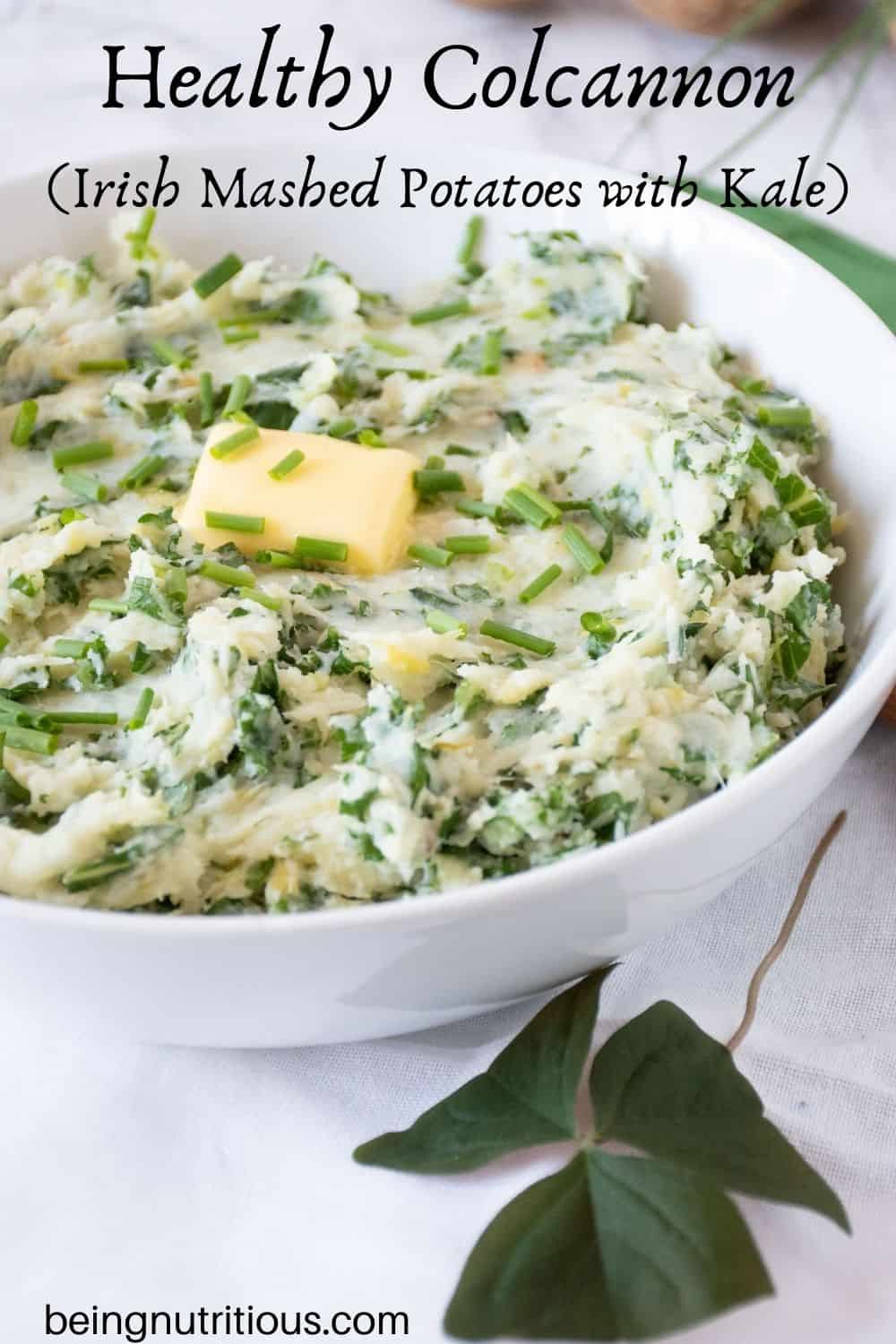 Bowl of Irish mashed potatoes with a pat of butter on top. Text overlay: Healthy Colcannon (Irish mashed potatoes with kale).