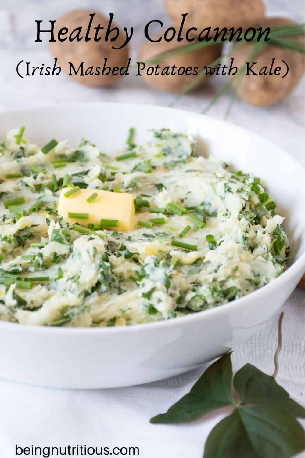 Bowl of Irish mashed potatoes with a pat of butter on top. Text overlay: Healthy Colcannon (Irish mashed potatoes with kale).