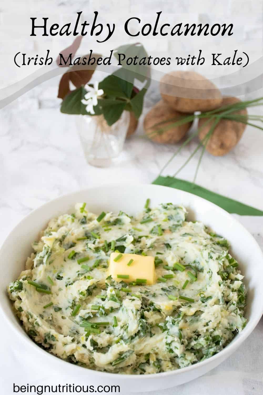 Bowl of mashed potatoes with a pat of butter on top. Text overlay: Healthy Colcannon (Irish mashed potatoes with kale).