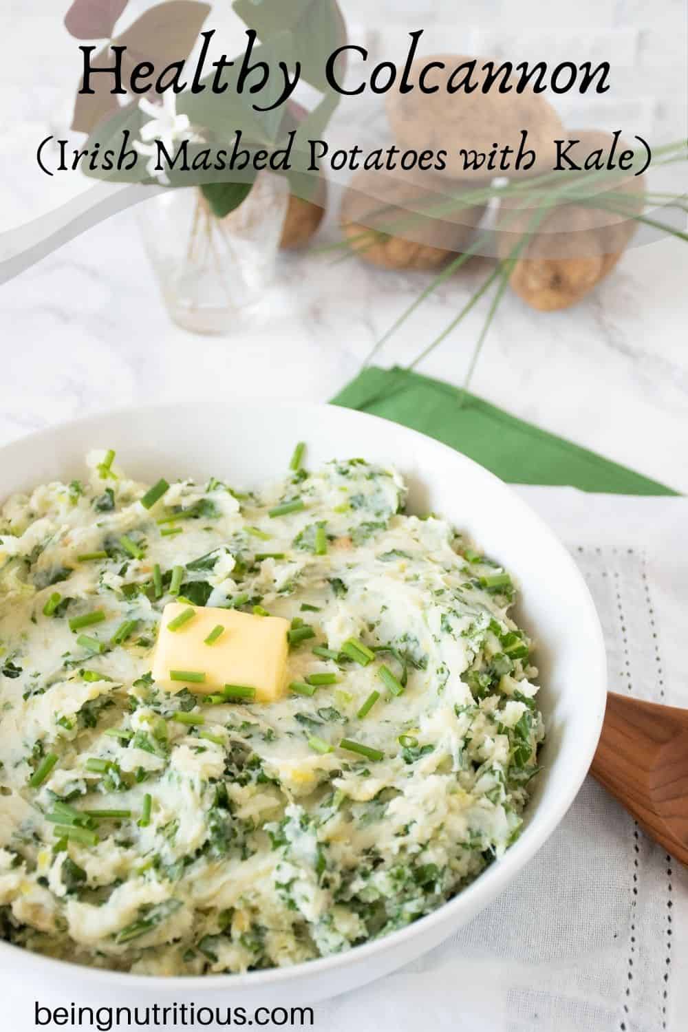 Bowl of mashed potatoes with a pat of butter on top. Text overlay: Healthy Colcannon (Irish mashed potatoes with kale).
