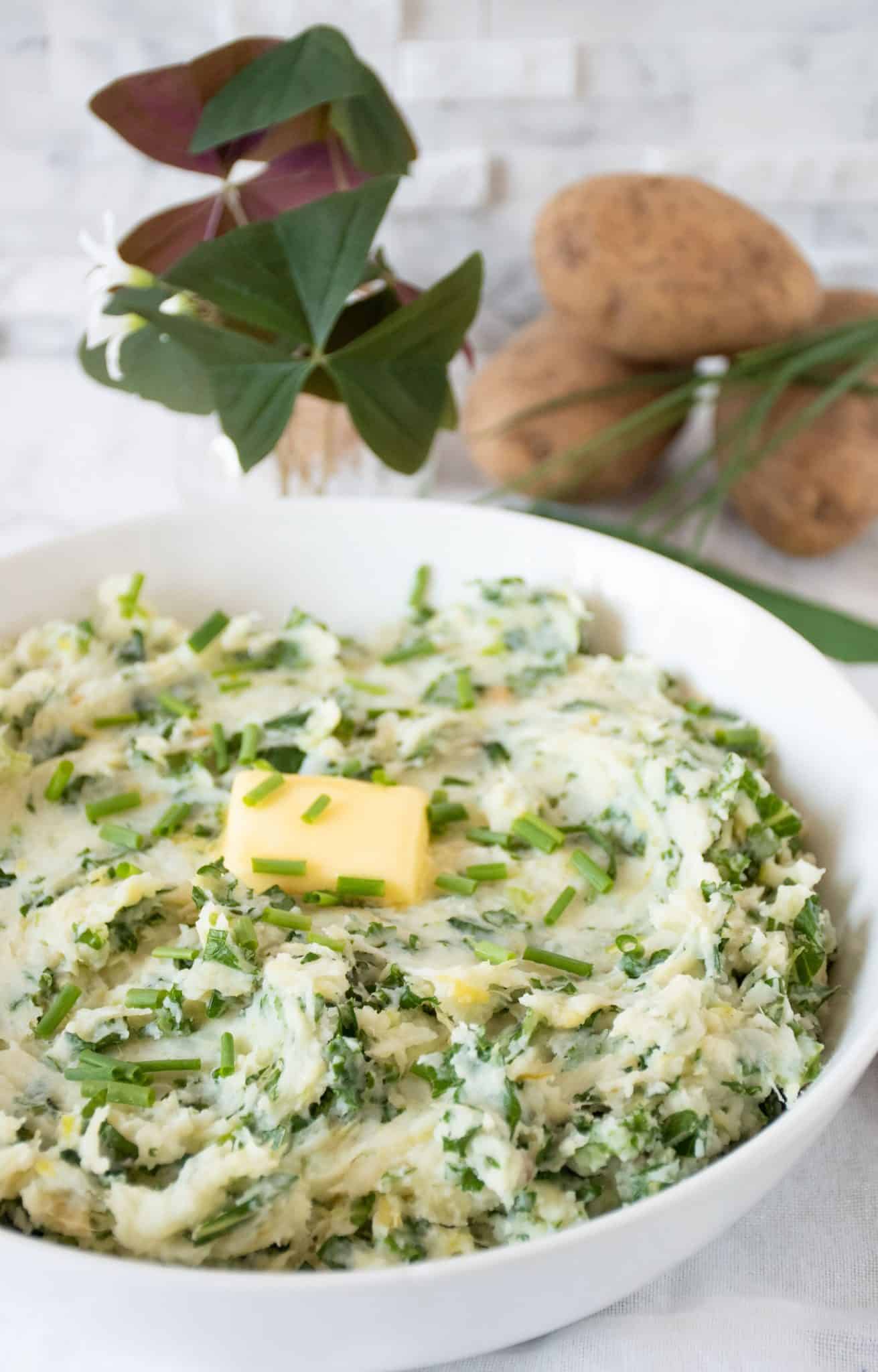Bowl of Irish mashed potatoes with a pat of butter on top.