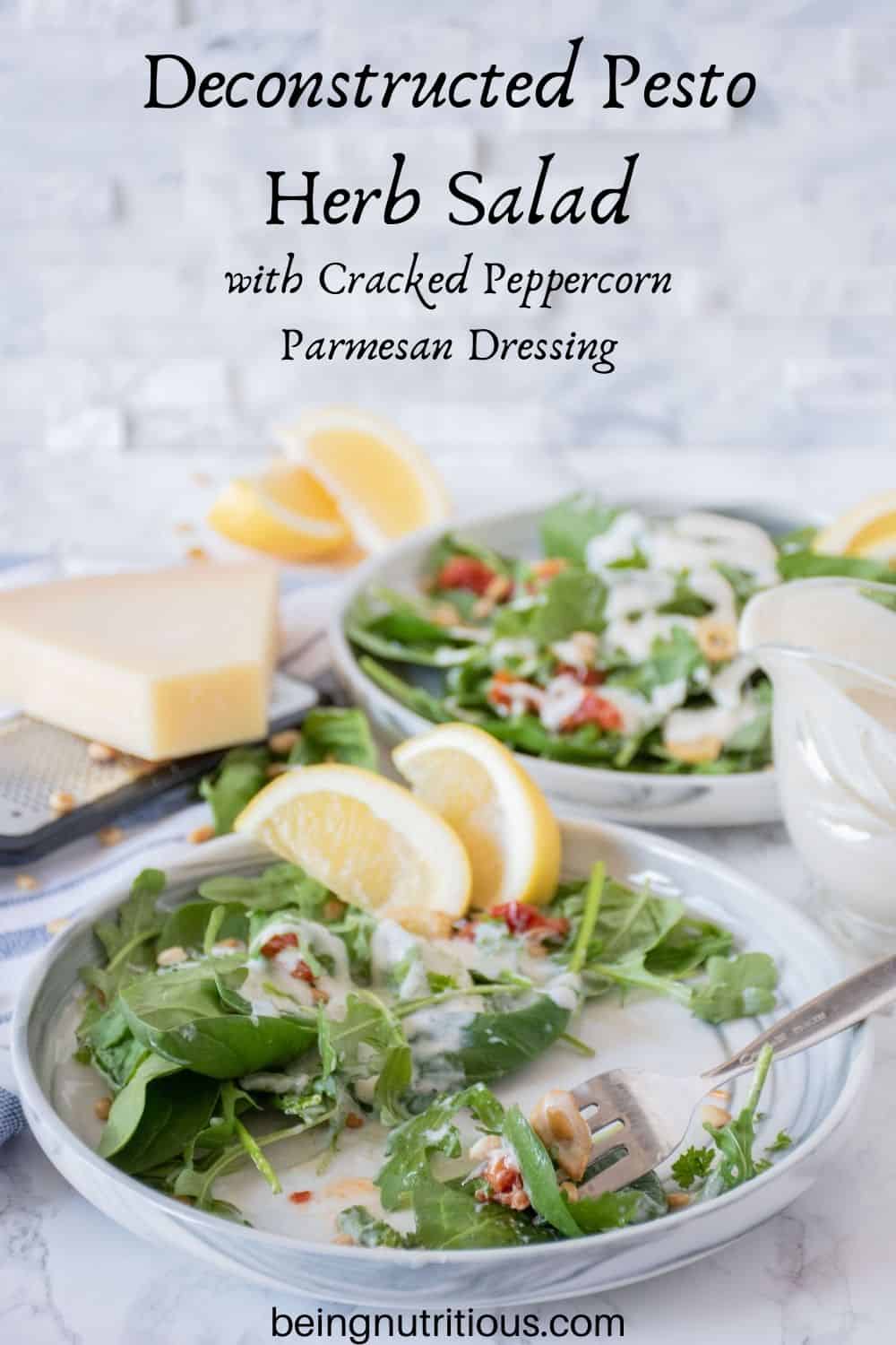 Plate of half eaten salad with sundried tomatoes, and fried garlic with dressing. Text overlay: Deconstructed Pesto Herb Salad with Cracked Peppercorn Parmesan Dressing