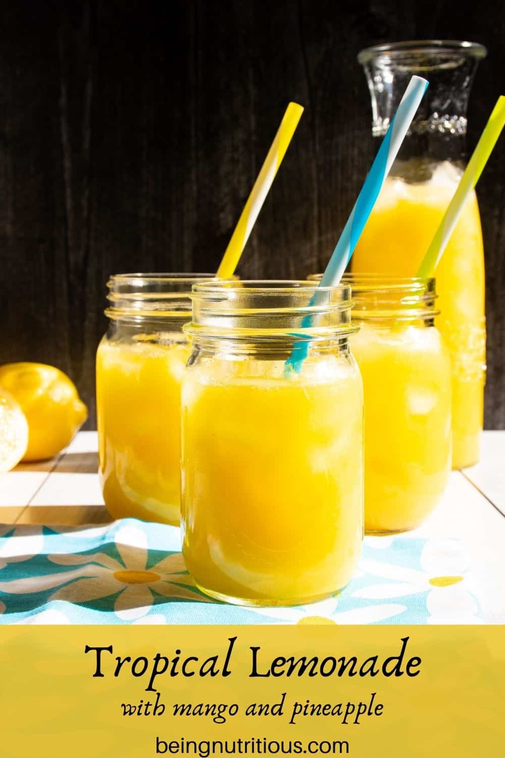 Three Mason jars with lemonade in them. Text overlay: Tropical Lemonade; with mango and pineapple