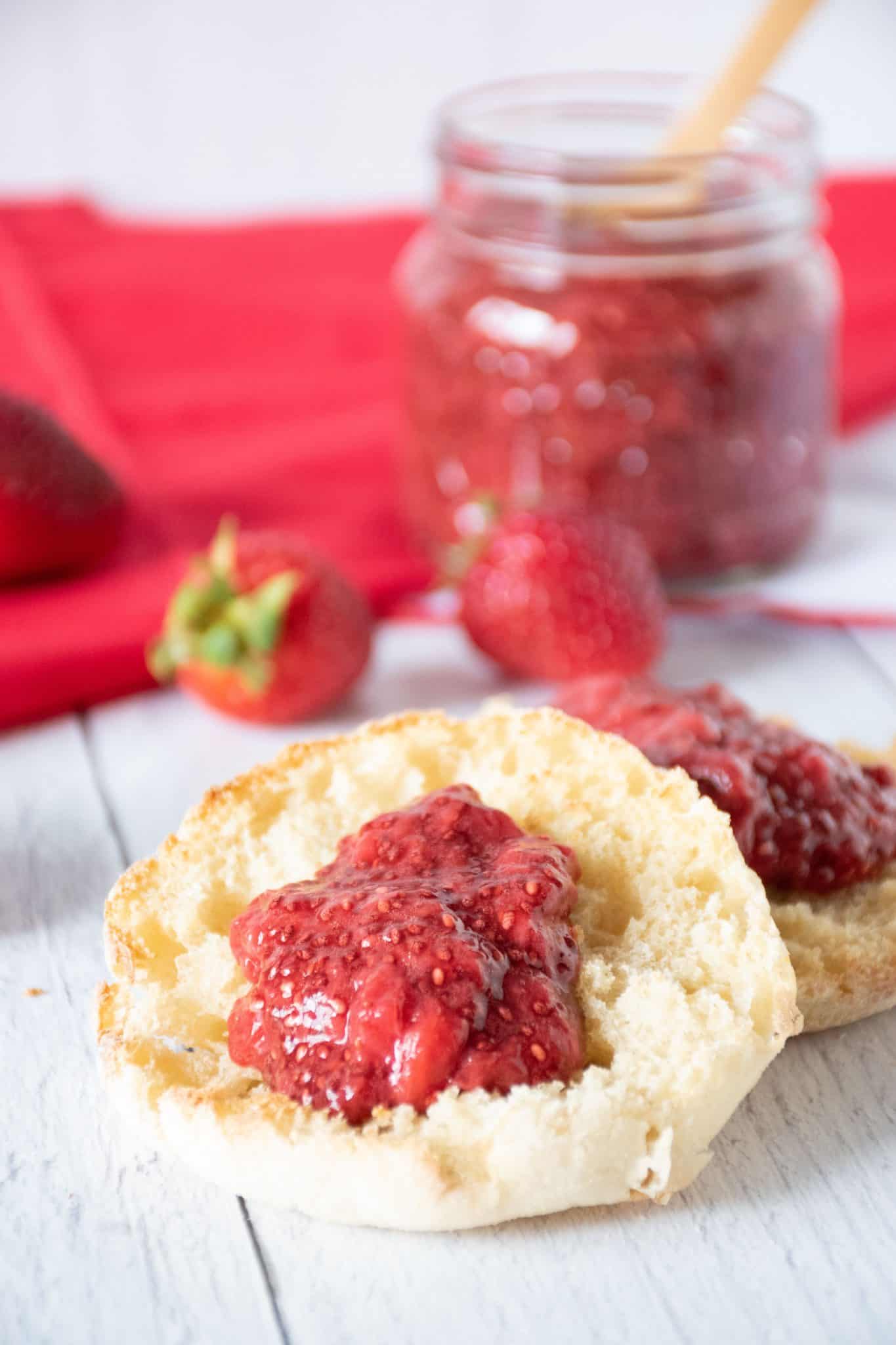 Toasted English Muffin with strawberry jam on it.