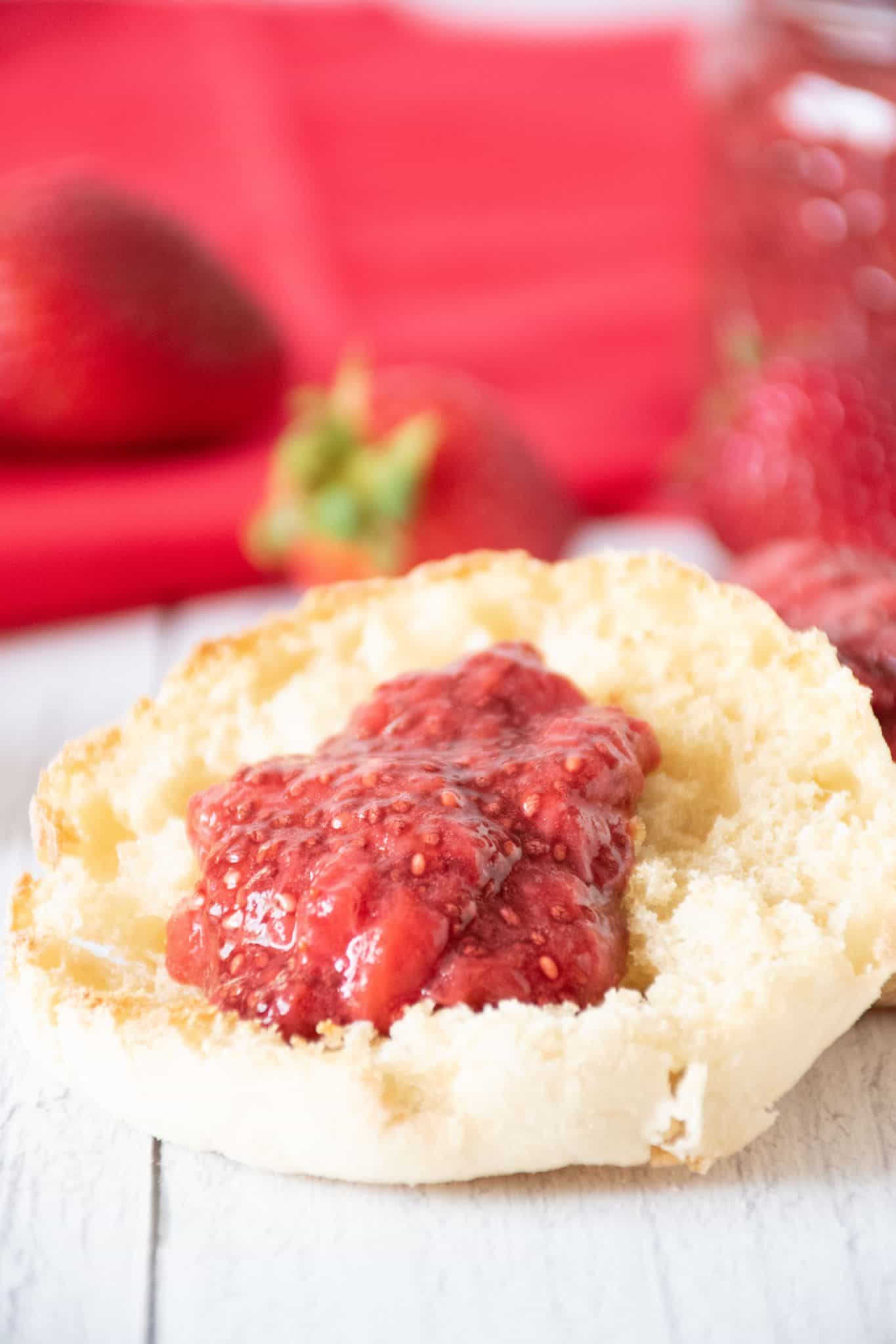 Toasted English Muffin with strawberry jam on it.