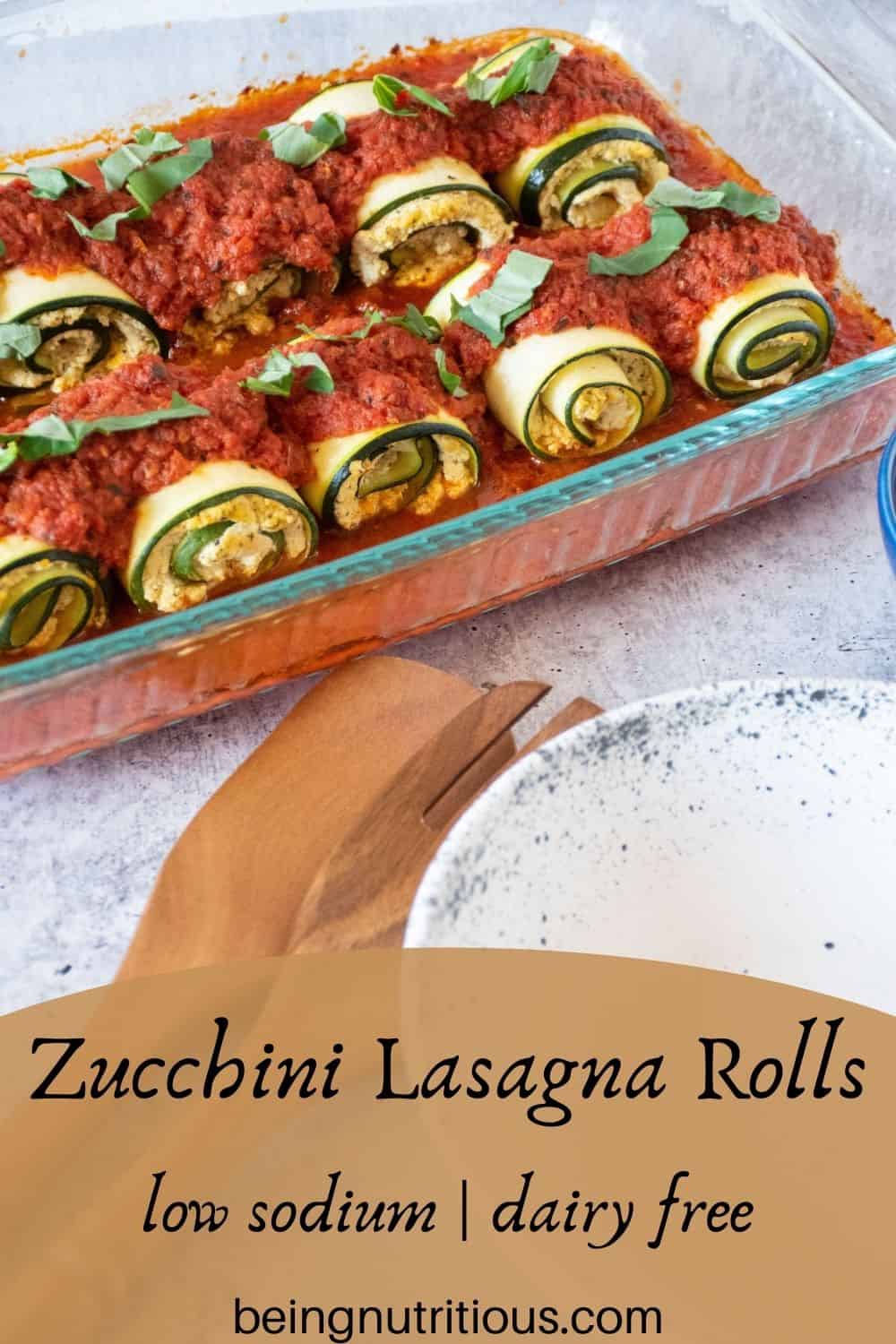 Casserole of zucchini rolls. Text overlay: Zucchini Lasagna Rolls; low sodium, dairy free.