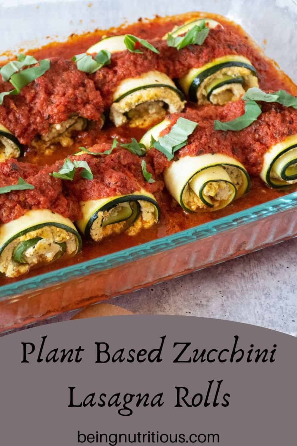 Zucchini rolls in a casserole. Text overlay: Plant Based Zucchini Lasagna Rolls.