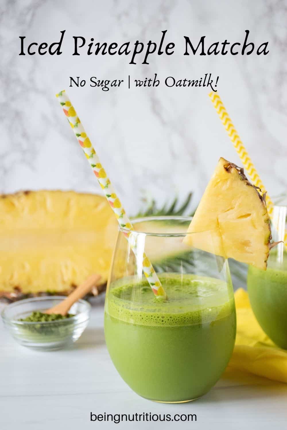 Glass of iced matcha drink, garnished with a pineapple slice. Text overlay: Iced Pineapple Matcha; no sugar, with oatmilk!