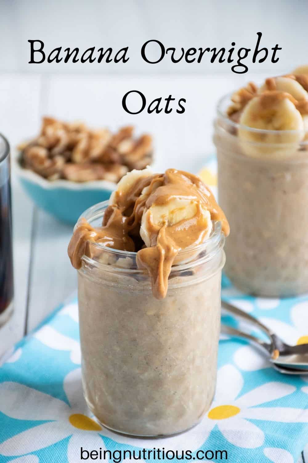 Small mason jar of oatmeal with walnuts and banana slices on top, with a drizzle of peanut butter. Text overlay: Banana Overnight Oats.