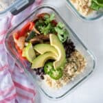 Glass meal prep container filled with burrito fillings.