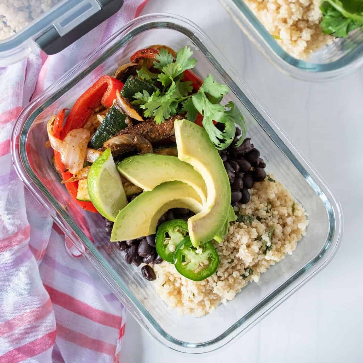 Glass meal prep container filled with burrito fillings.
