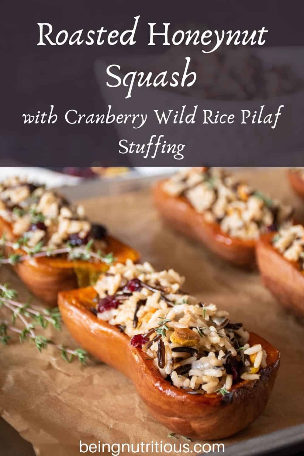 Stuffed honeynut squash halves on a baking pan. Text overlay: Roasted Honeynut Squash with Cranberry Wild Rice Pilaf Stuffing.