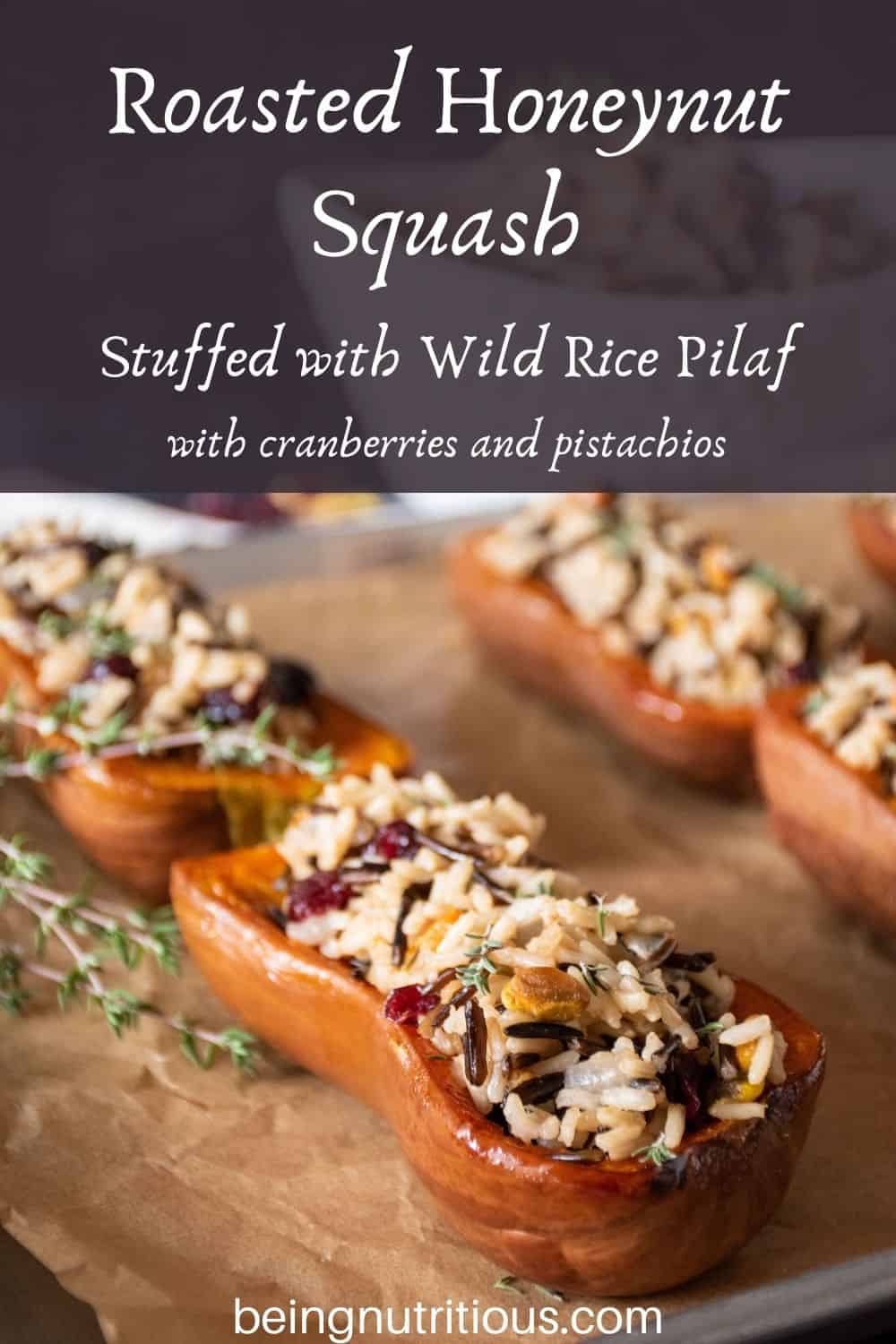 Stuffed honeynut squash halves on a baking pan. Text overlay: Roasted Honeynut Squash Stuffed with Wild Rice Pilaf, with cranberries and pistachios.
