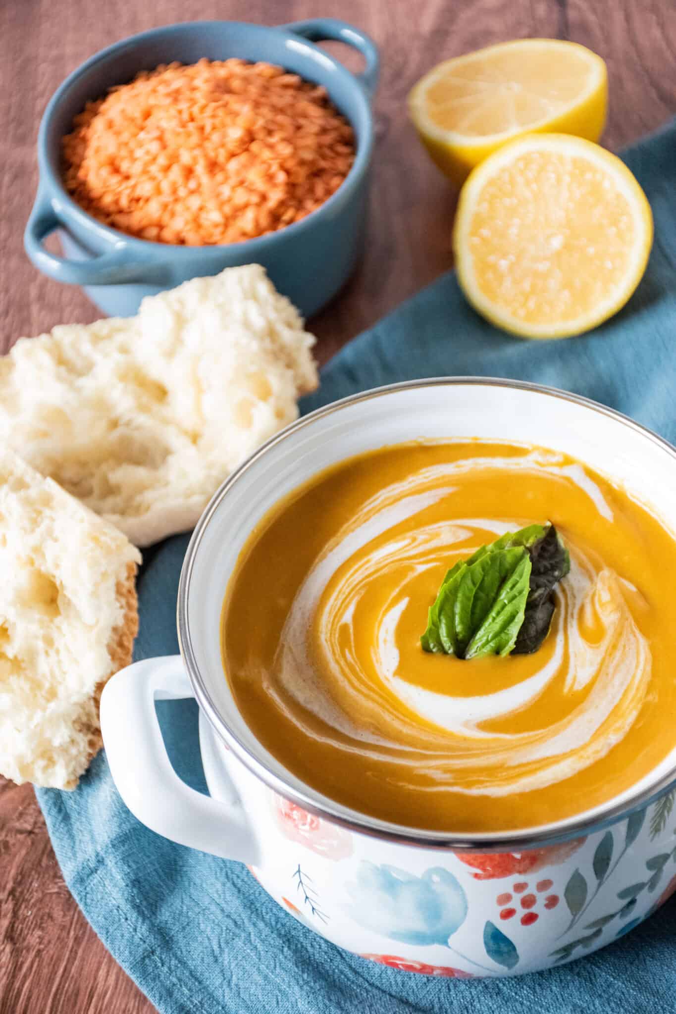 Small crock of creamy soup, garnished with basil leaves.