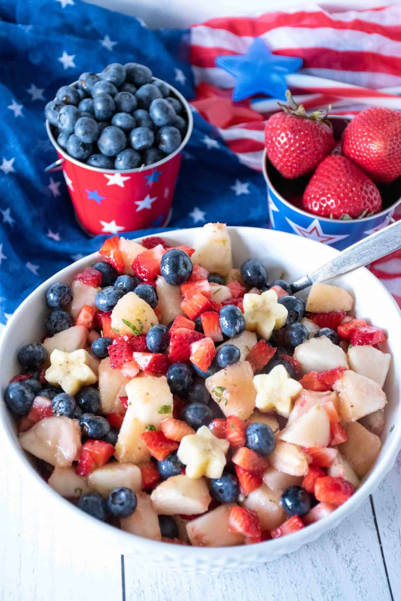 Bowl of red, white and blue fruit salad.