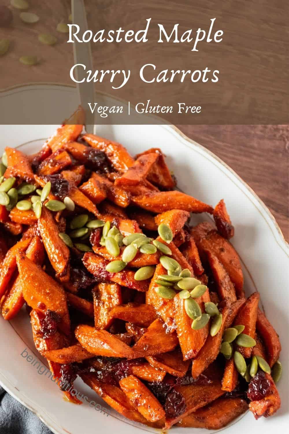 Oval plate with glazed carrots on it, garnished with pepitas. Text overlay: Roasted Maple Curry Carrots; Vegan, gluten free.