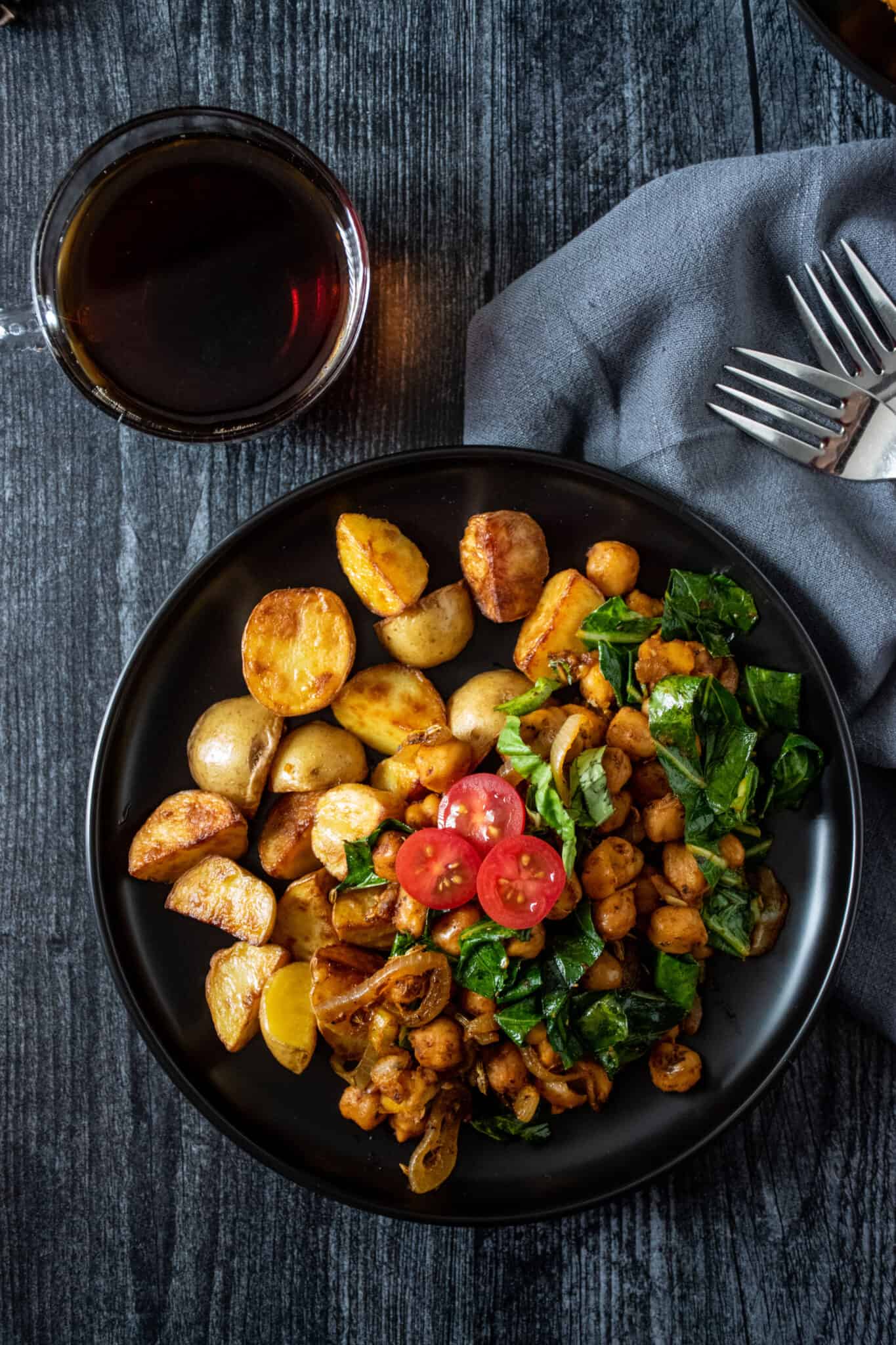 Overhead of chickpea breakfast skillet on a plate, with potatoes.