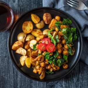 Overhead image of chickpea breakfast skillet on a plate, with breakfast potatoes.
