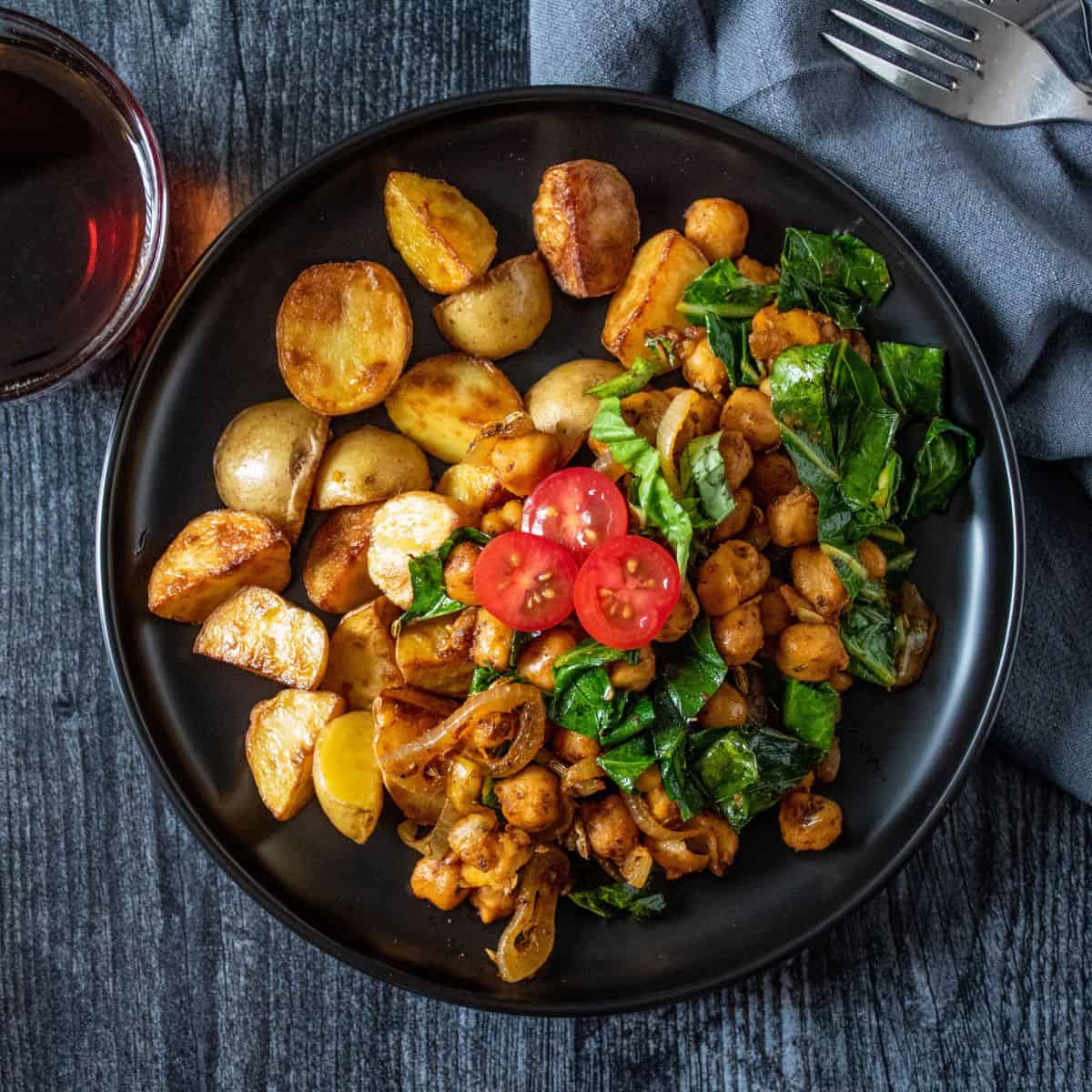 Overhead image of chickpea breakfast skillet on a plate, with breakfast potatoes.