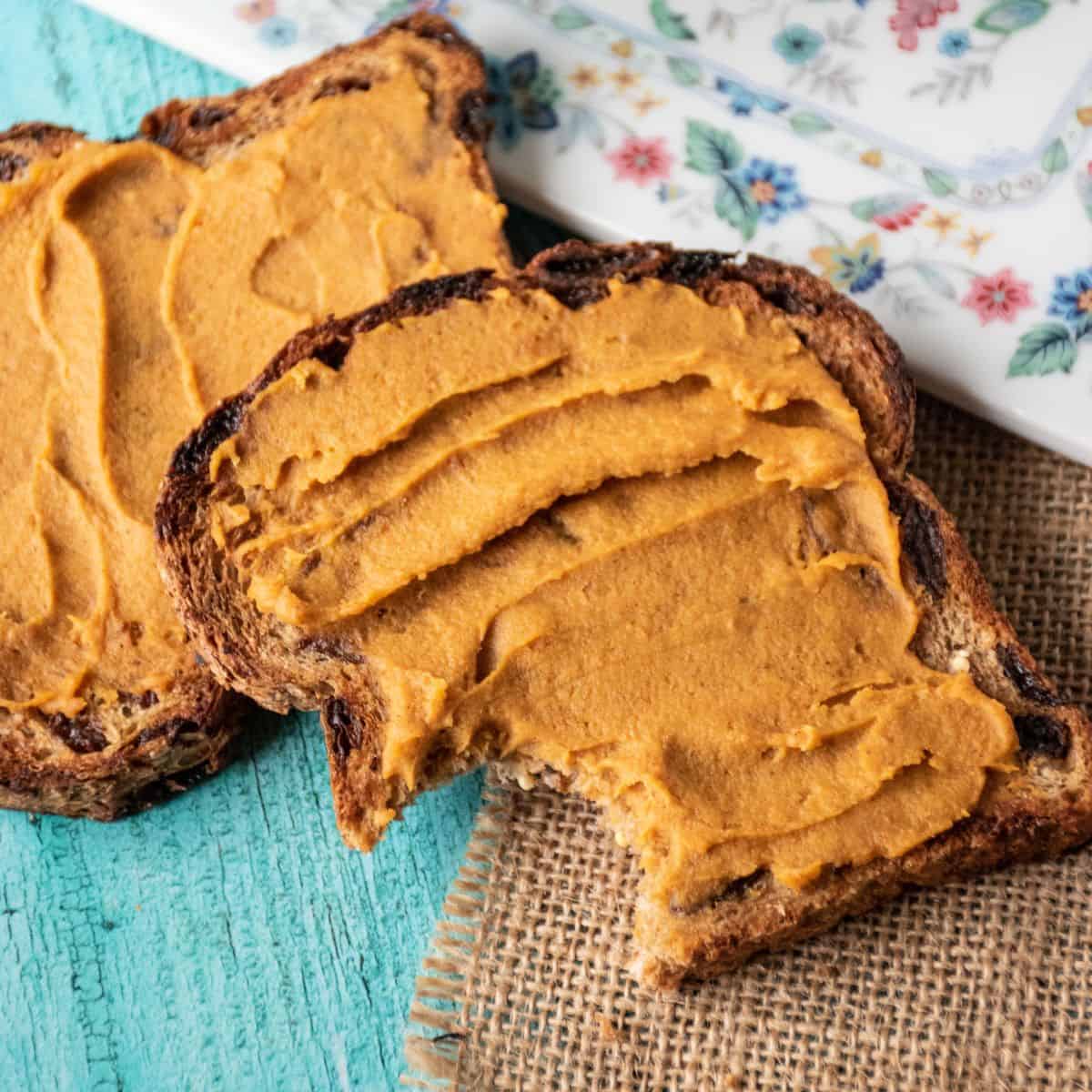 Two pieces of toast with a spread made of sweet potatoes and peanut butter.