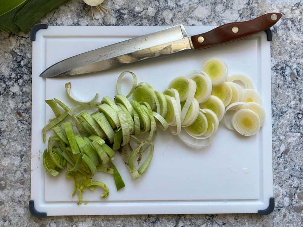 Sliced leeks on a cutting board.