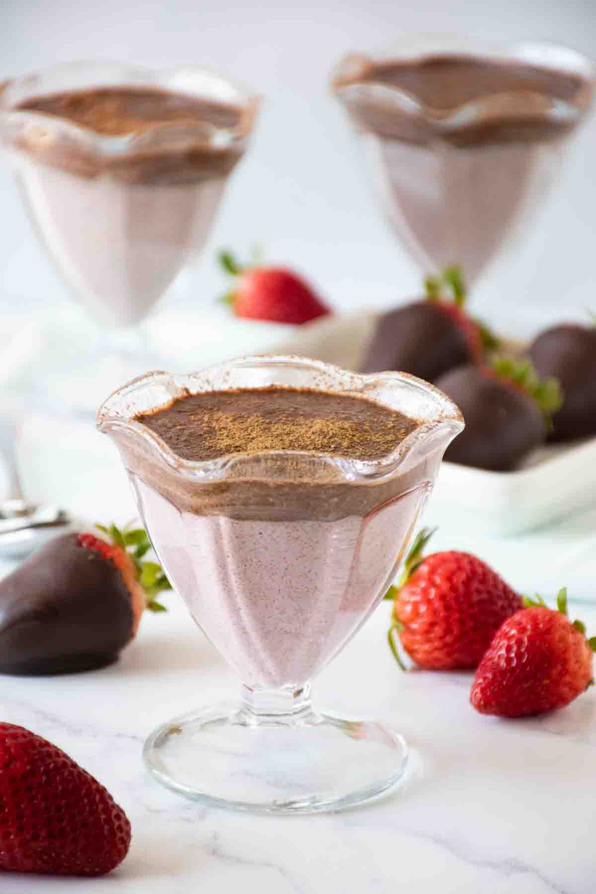 Dessert cup with strawberry chia pudding and chocolate pudding in it.