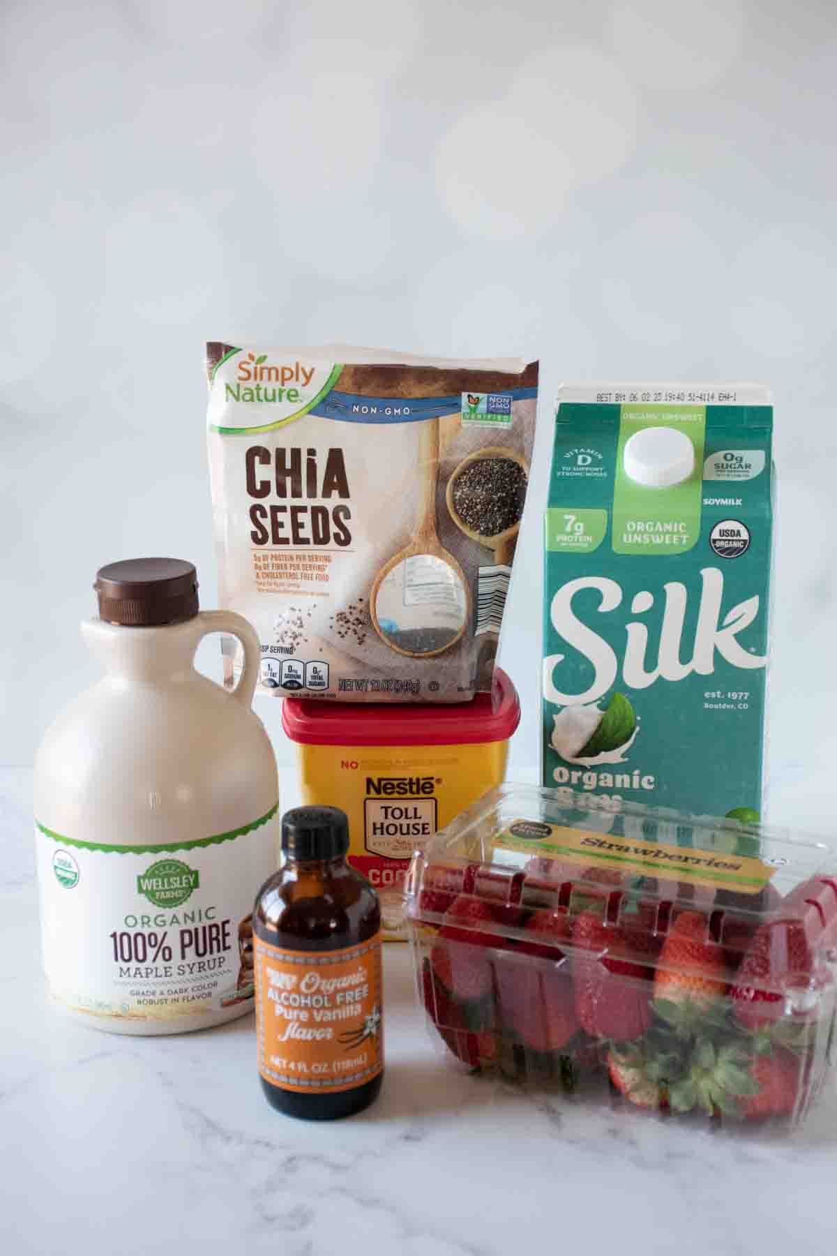 Collection of ingredients for chocolate strawberry chia pudding.