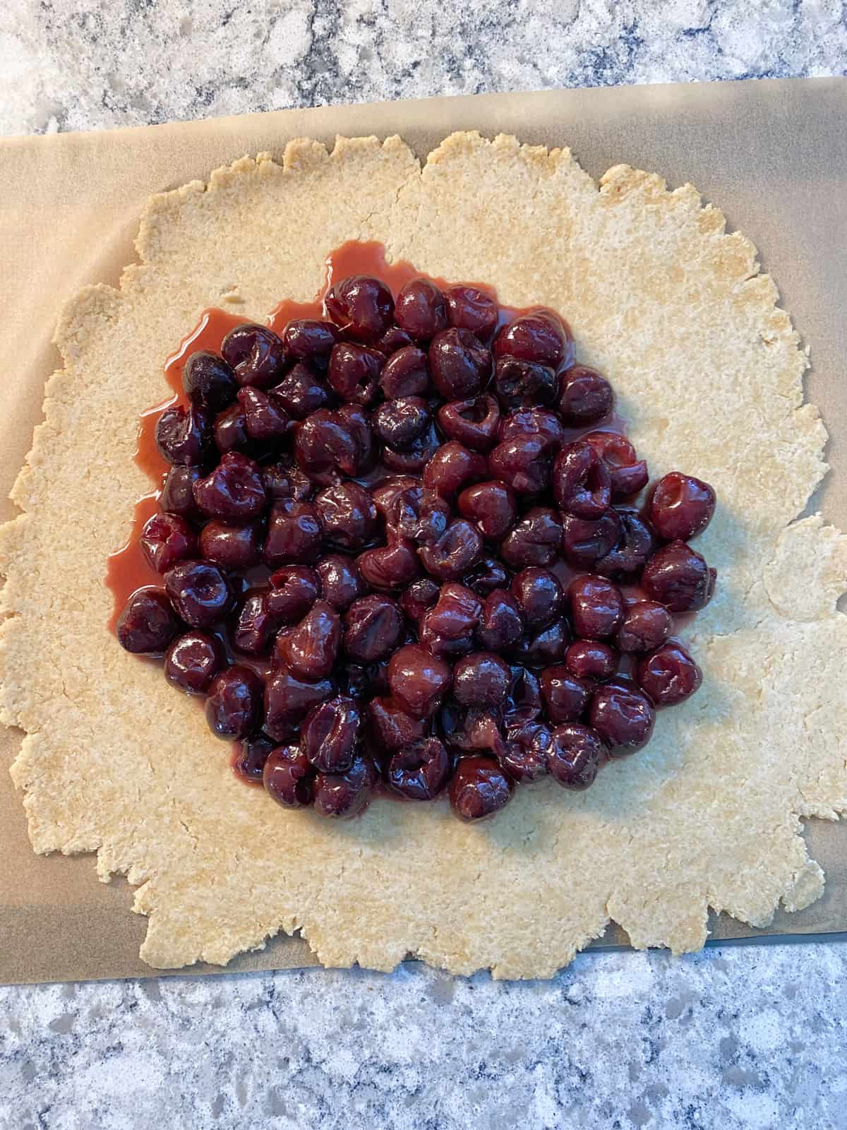 Cherry filling on the middle of the dough.