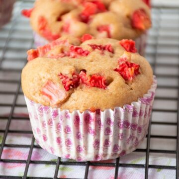 Close up of a strawberry muffin on a wire rack.