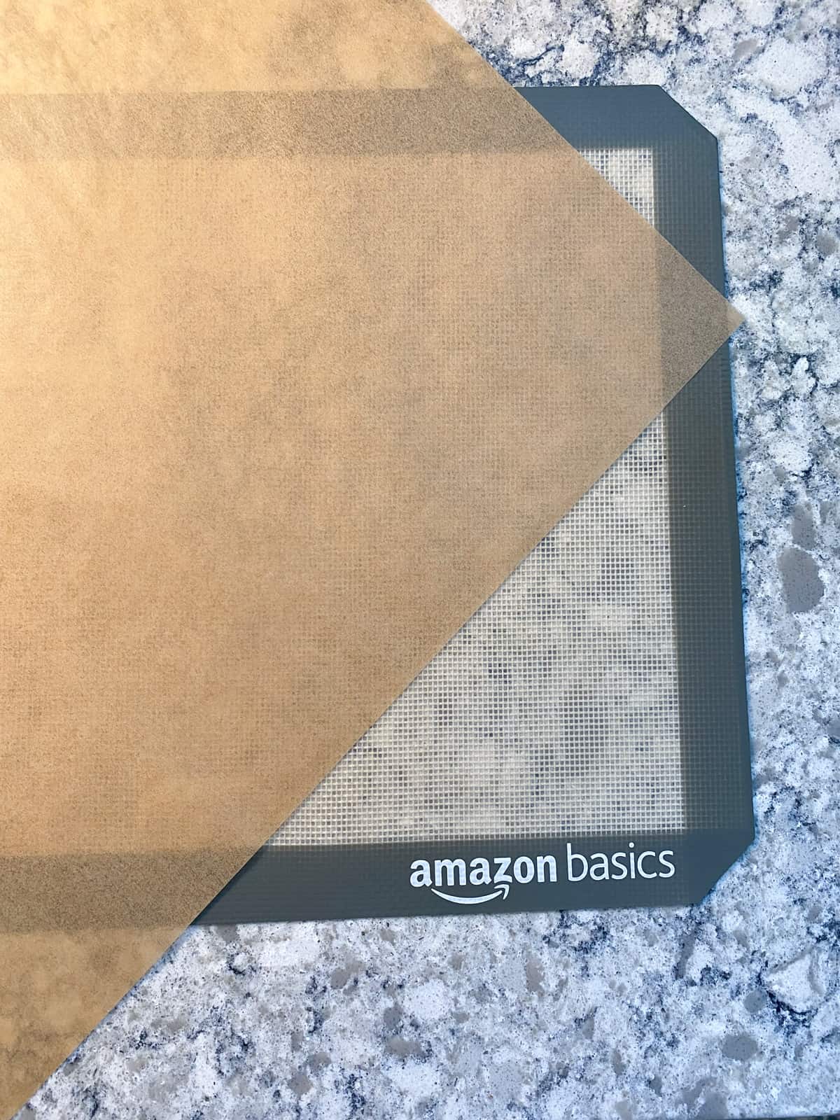 Piece of parchment paper over a silicone baking mat, to prevent sliding when rolling out dough.