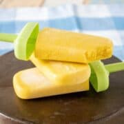 Pile of 3 popsicles lying on a dish.