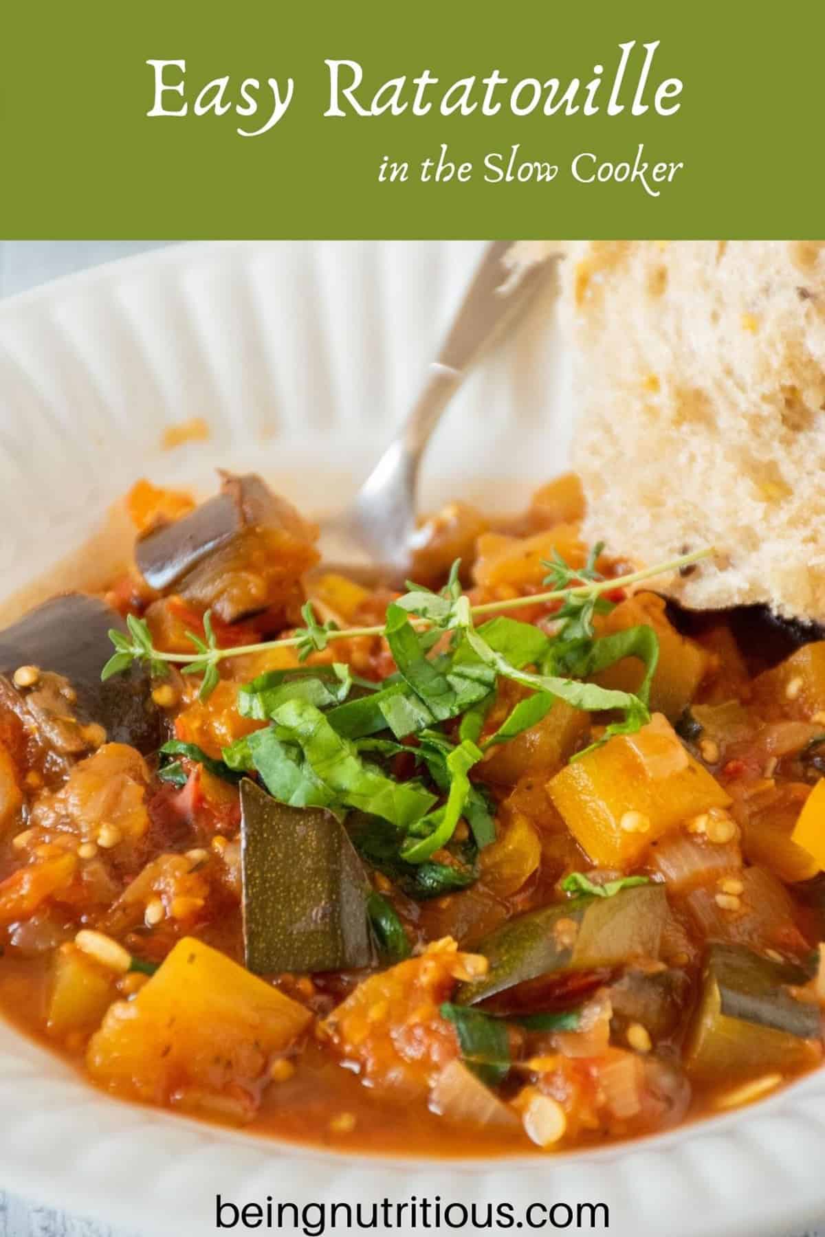 Bowl of ratatouille with a piece of crusty bread on the side. Text overlay: Easy ratatouille in the slow cooker.