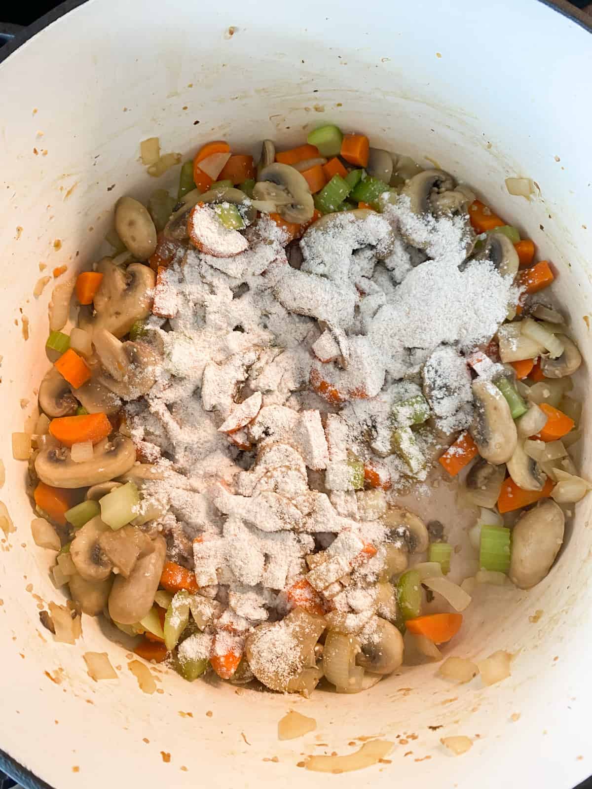 Flour sprinkled over sautéed vegetables.