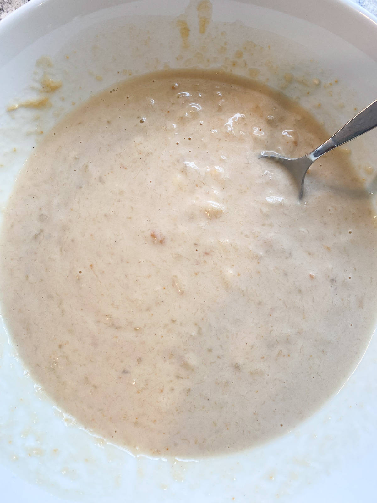 Mixed wet muffin ingredients in a bowl.