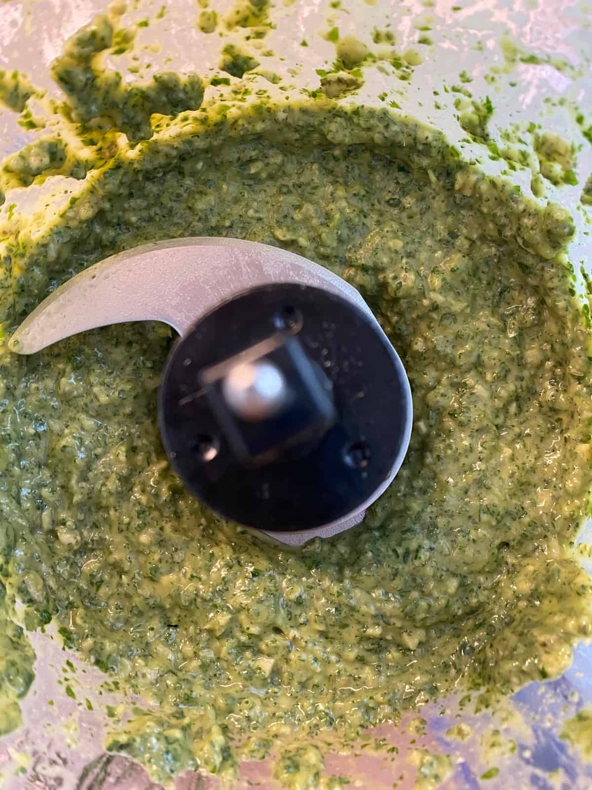 Blended pesto with pumpkin seeds in a food processor.