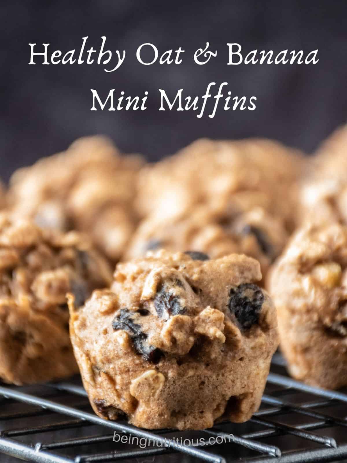 Close up of a mini muffin on a cooling rack with the rest of the muffins in the background. Text overlay: Healthy Oat and Banana Mini Muffins.