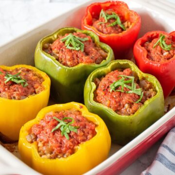 A pan of 6 baked stuffed bell peppers.