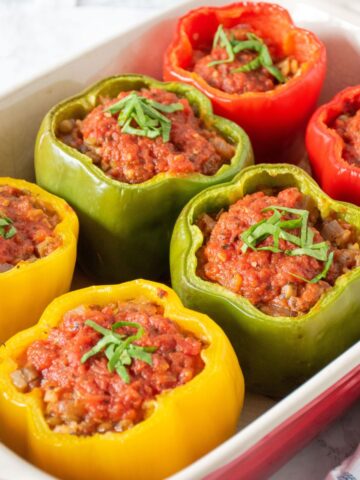 A pan of 6 baked stuffed bell peppers.