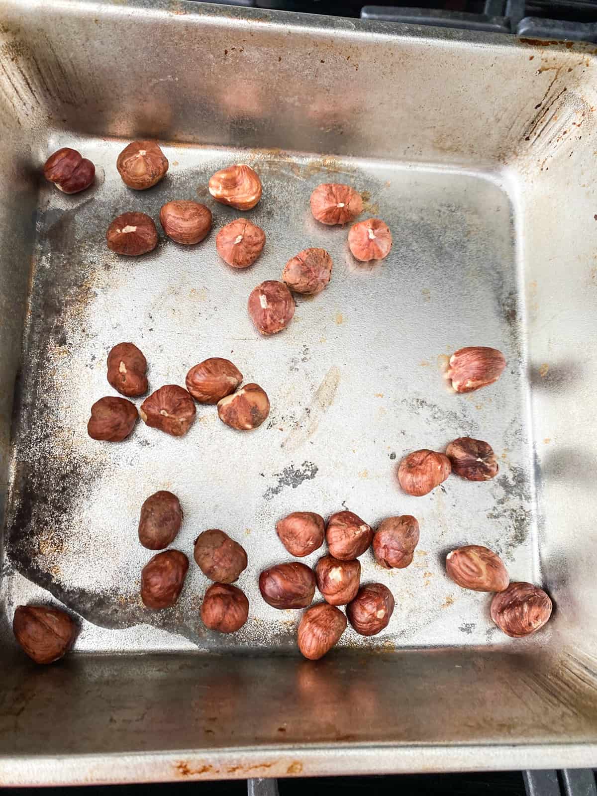 Hazelnuts in a roasting pan.