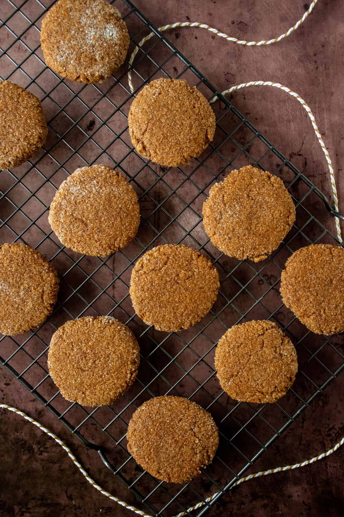 Ginger cookies on a cooling rack, from overhead.