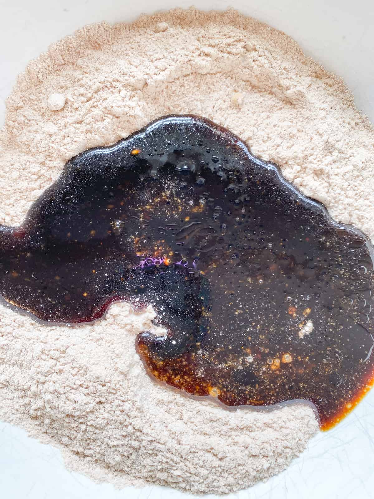 Wet ingredients poured into dry ingredients, in a bowl.