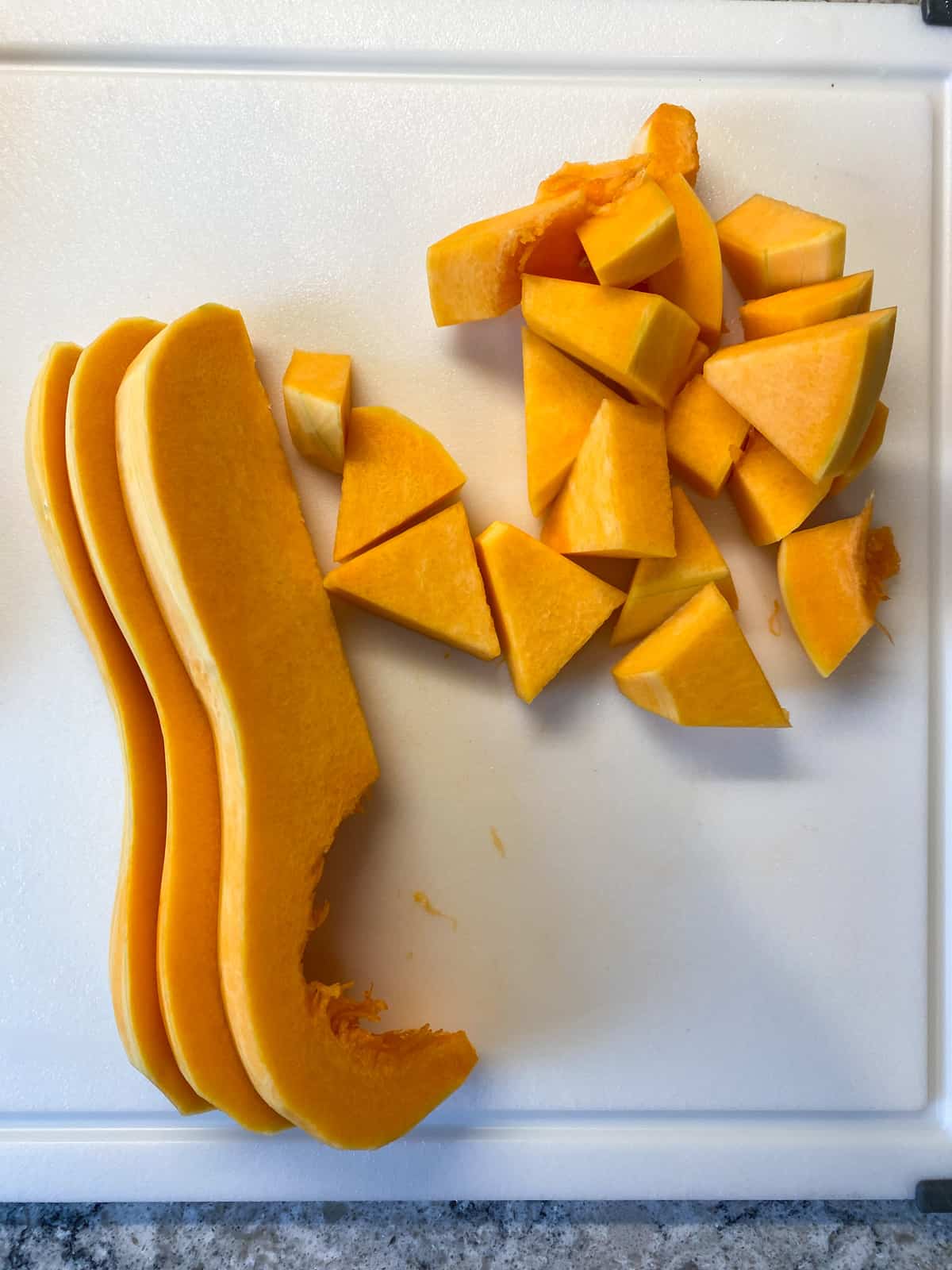 Chopped butternut squash on a cutting board.