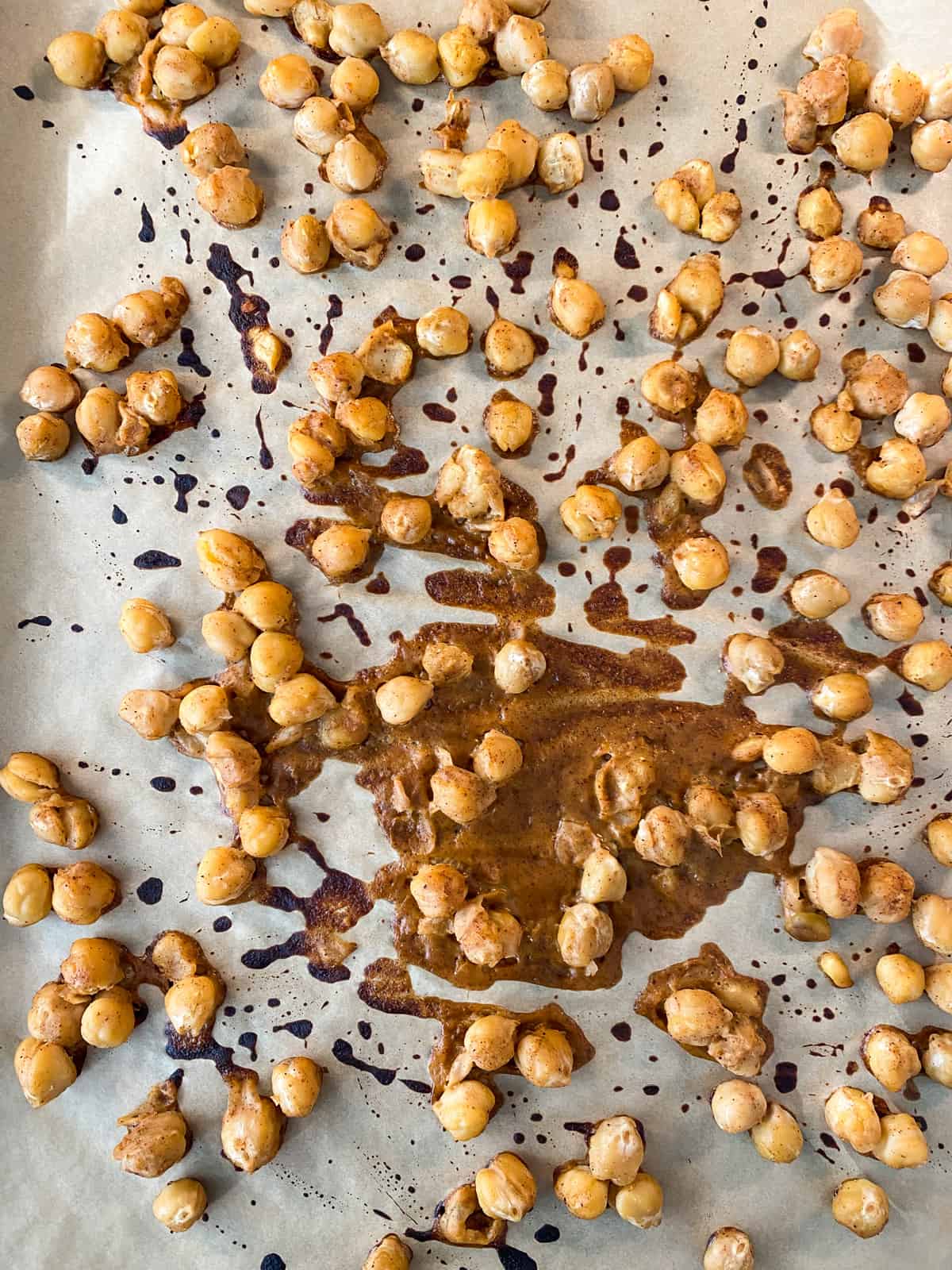 Baked buffalo chickpeas on a baking sheet.
