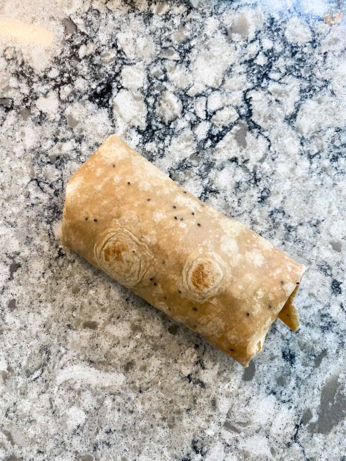 Buffalo chickpea wrap - rolled into a wrap and ready to eat.